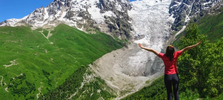 woman-wearing-red-shirt-standing-at-swis-alps. 